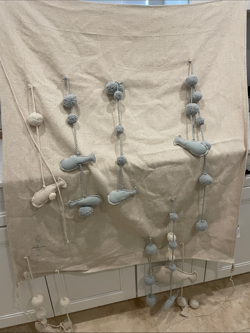 100% cotton Lorena Canals Neutral and Light Blue Pom-Pom Fish Hanging Wall Decor